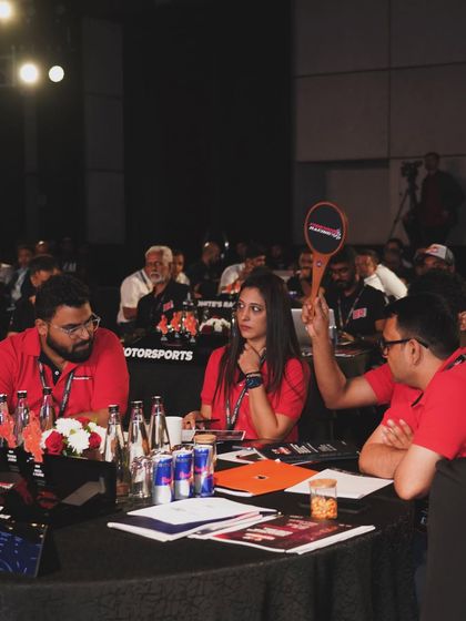 A team at their table during the ISRL auction. This shot captures the intense and focused atmosphere of the bidding process we managed.
