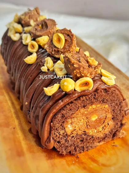 My Decadent Ferrero Swiss Roll is pure indulgence. Made with rich couverture dark chocolate and packed with Ferrero Rocher pieces inside and out, it's a travel-friendly dessert that's perfect for sharing.