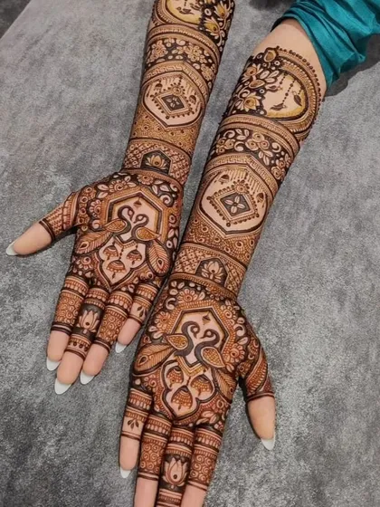 A beautiful peacock-themed design with intricate details on the palms and arms. The symmetry and fine line work make this a very elegant choice.