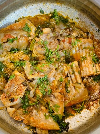 A pot full of the delicious and fatty fish curry.