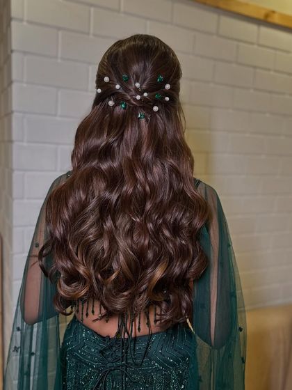 Another angle of the pearl-pinned half-updo, showing the neatness of the style and the beautiful cascade of waves.