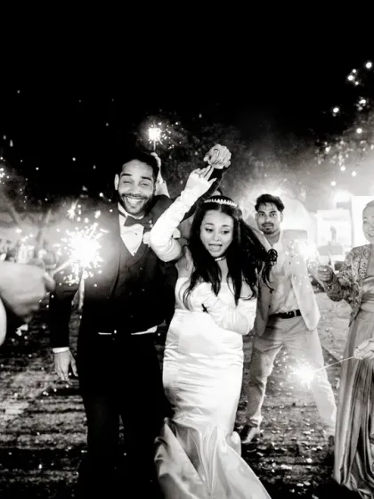 A magical exit under a tunnel of sparklers. This black and white photo captures the joy and celebration of the moment perfectly.