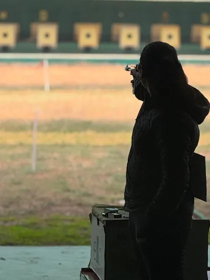 A silhouette of a shooter in perfect form during the 67th National Shooting Championships. This level of focus is what we cultivate during our mental training sessions.