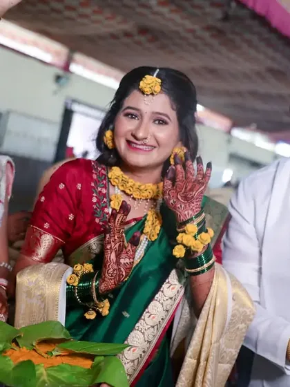 The bride's joyful expression during her Haldi ceremony, surrounded by friends and family. These are the candid moments of pure happiness we love to capture.