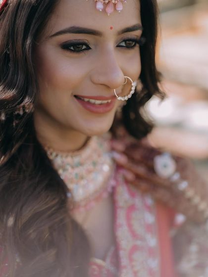 A close-up of a bride's happy expression, capturing her natural smile and the details of her makeup.