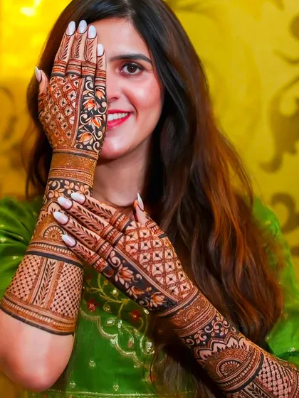 A happy client showing off her full-arm bridal mehndi. My goal is to make you smile with a design you will love and cherish.