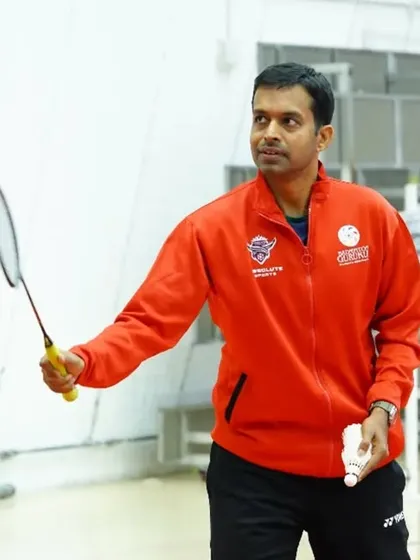 Pullela Gopichand during the inauguration of our first international venture in Qatar, holding a racket and ready to inspire.