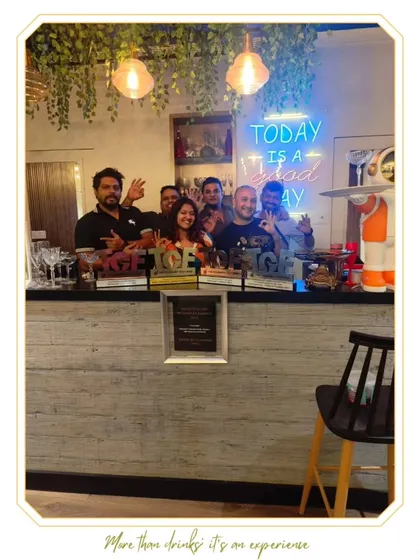 Our team behind the bar at our academy, celebrating our recent award wins. The "Today is a good day" neon sign perfectly captures the feeling of this achievement.