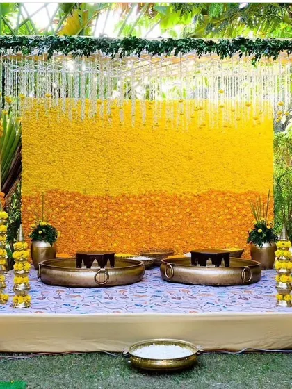 A Haldi ceremony is all about vibrant yellows and joyful celebration. I design classic Haldi stages using walls of fresh marigolds and traditional brass urlis, creating the perfect sun-kissed setting for your pre-wedding rituals.