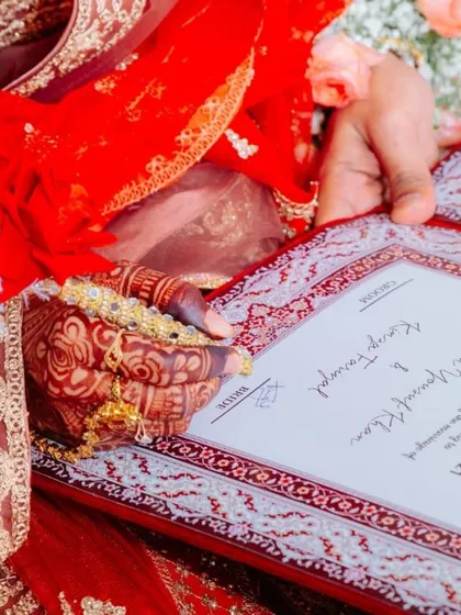 Another angle showing the bride signing her marriage contract. You can see the detail on her dress and the custom pen, all coming together to create a perfect picture.