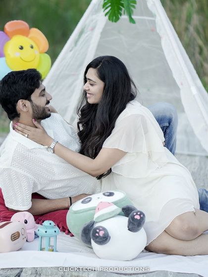 An affectionate pose during a picnic-themed shoot, with the bride caressing the groom's face.
