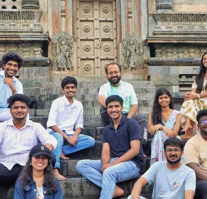 The crew sitting on the steps of a beautiful old temple in Agumbe.