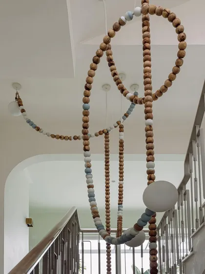 A close-up of the LUNA installation shows the texture of the wooden beads and the soft glow of the integrated lights. It's a piece that is as beautiful up close as it is from a distance.