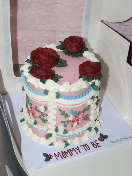 A closer look at the intricate floral piping on our vintage baby shower cake. Every petal and leaf is carefully crafted to create a beautiful, edible bouquet.