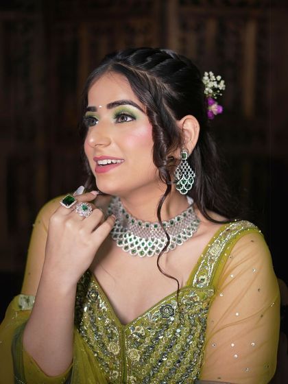 This peacock green Anarkali-style lehenga is perfect for a Mehendi or Sangeet look. The emerald jewellery adds a touch of luxury.