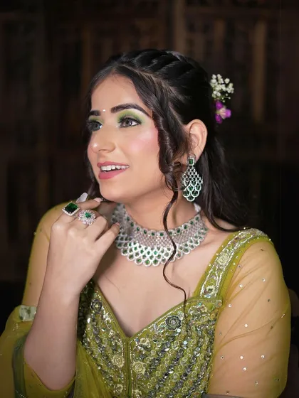 This peacock green Anarkali-style lehenga is perfect for a Mehendi or Sangeet look. The emerald jewellery adds a touch of luxury.