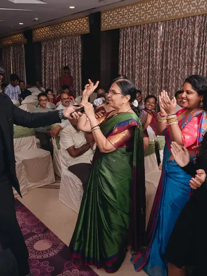 Getting everyone to dance, no matter their age. Here, I'm sharing a dance moment with one of the elders at a wedding, proving that joy and music have no age limit.
