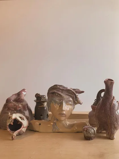A collection of a self-taught artist's work, showcasing a range of imaginative and surrealist sculptures.