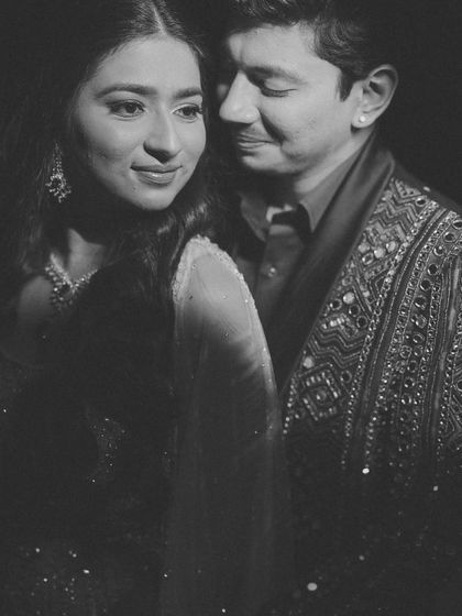 A timeless black and white portrait that focuses on emotion. The soft lighting and close framing highlight the couple's gentle expressions and deep connection, creating a truly soulful image.