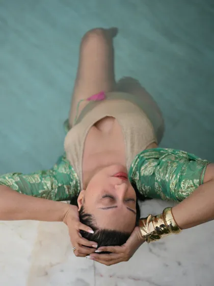 Unbothered and shining. A serene moment in the pool, wearing a gold swimsuit and a statement cuff bracelet. Vacation style is also about how you feel: relaxed and confident.