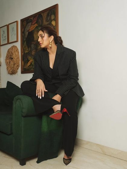 An indoor lifestyle shoot with actress Huma Qureshi. This relaxed, cross-legged pose on the sofa feels natural and confident.
