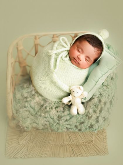 This little one is all cozied up in a mint green knit cocoon with a matching bonnet and a tiny teddy bear friend. The textures and soft colors make this shot so heartwarming.