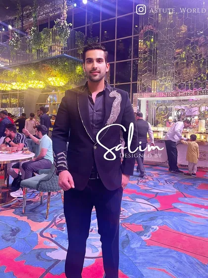 A client at an event wearing a black blazer with unique silver embroidery on the lapel and cuff. This shows how my pieces are designed to be seen and admired.