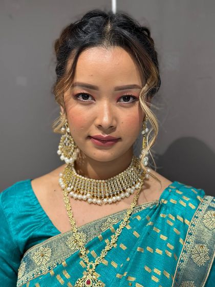 A confident portrait of the model, showcasing the complete South Indian bridal makeup and styling done by our students.