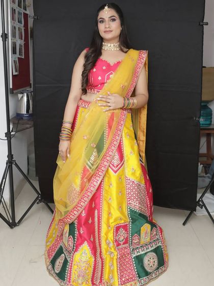 A full-length view of the pink, yellow, and green lehenga, a perfect outfit to stand out at your Haldi or Mehendi.
