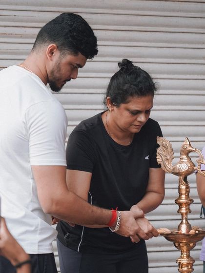 Assisting with the lamp lighting ceremony, a moment of shared purpose.