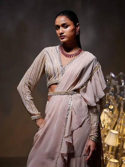 The Elsa Saree Set, where the intricately embellished blouse and hand-adorned belt add a layer of sophistication to the modern ruffle saree.