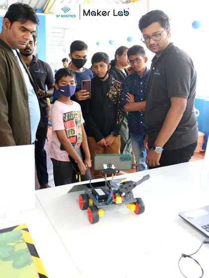 Visitors at our expo get a close look at a student-built rover, learning about its components and functions from our expert team.