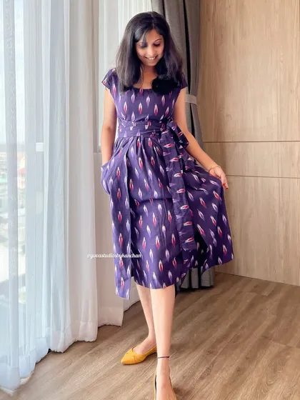 I designed this purple Ikat pinafore dress for a chic and comfortable fit. The side tie adds a lovely detail, and the pure handloom fabric feels wonderful against the skin.