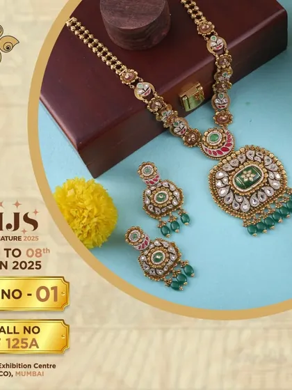 A magnificent bridal set featuring a Kundan-style pendant with green stone embellishments. This piece exemplifies how we blend traditional designs with precious stones to create high-value items for your store.