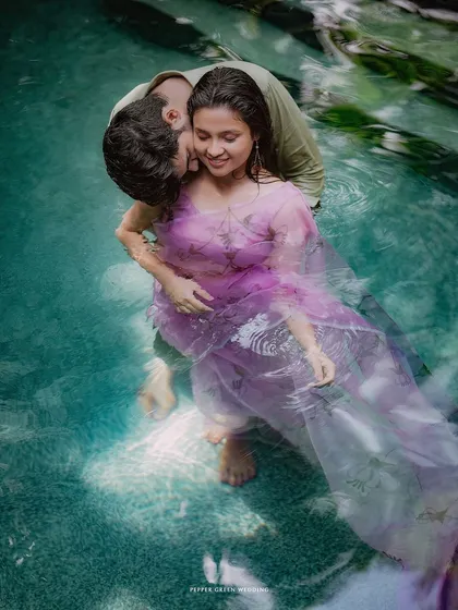A romantic embrace in the clear water of a pool. A water-themed pre-wedding shoot can add a unique and artistic element to your love story.
