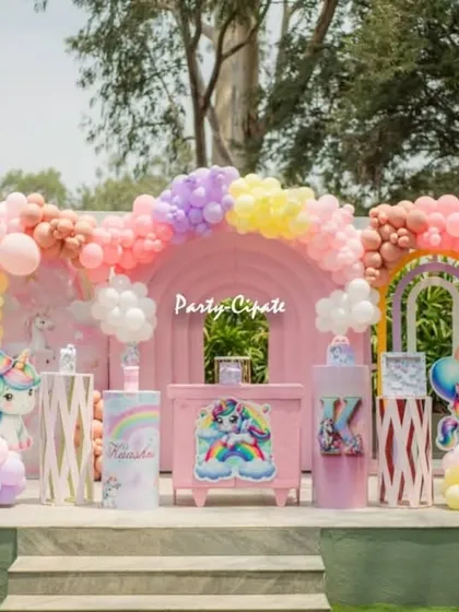This outdoor unicorn party was a pastel dream. I used a large rainbow-arched backdrop, fluffy balloon clouds, and cute unicorn cutouts to create a magical setting. The open space at the farmhouse venue was perfect for this theme.