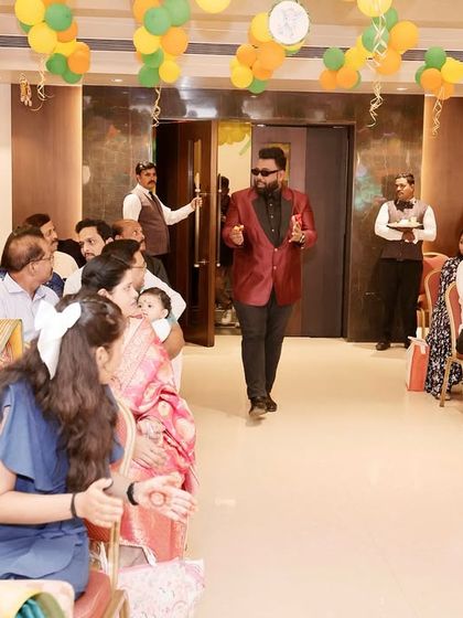 Making my entrance at a family gathering. I love to start by walking through the crowd, ready to surprise guests with some impromptu magic.