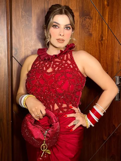 This pose highlights the intricate details of the dress and the beautiful accessories.