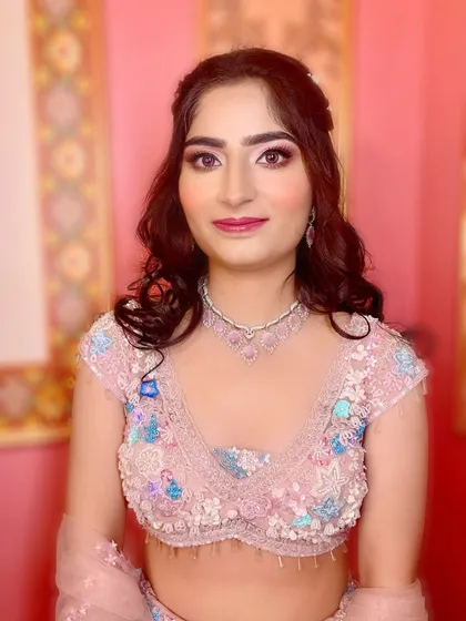 A close-up of the engagement makeup. The soft pink tones on the eyes and lips perfectly complement her pastel outfit and diamond jewelry.