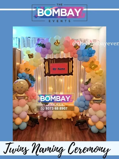 Another beautiful naming ceremony for twins. This setup uses a soft pastel color palette and a wooden frame to announce the names.