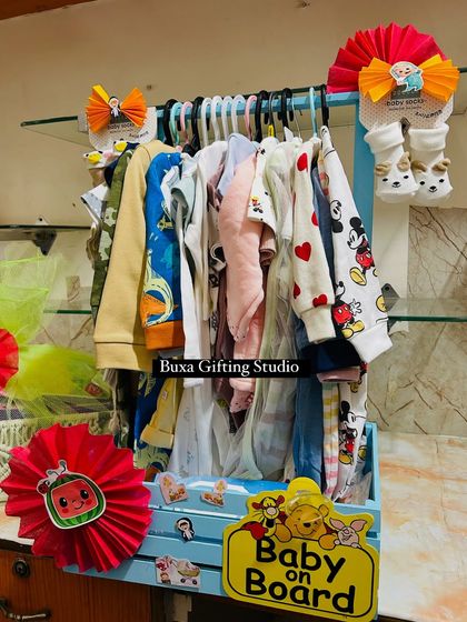 The "Baby on Board" hamper, filled with a wardrobe of adorable clothes, including Mickey Mouse and heart-printed onesies.