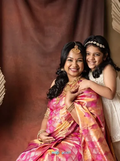 Two generations of beauty! This mom-to-be and her daughter look so lovely together in their traditional outfits. It’s a wonderful way to include the older sibling in the maternity celebration.