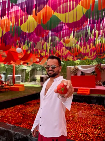 Holding up a tomato before the madness begins. This La Tomatina party was one for the books.