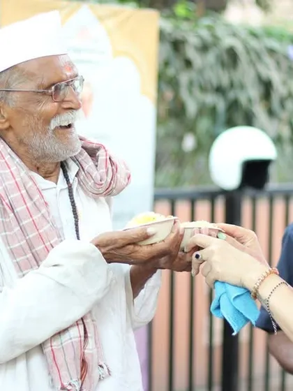 A volunteer sharing a moment of connection while serving a meal. The act of giving nourishes both the receiver and the giver, creating a cycle of kindness and compassion.