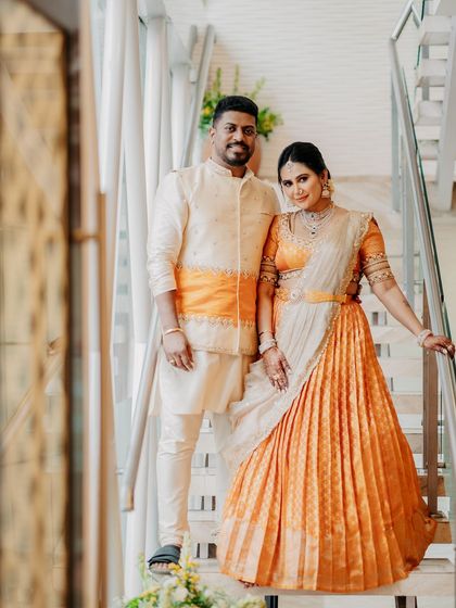 A full-length view of the couple, showing how their coordinated outfits create a complete and harmonious picture.