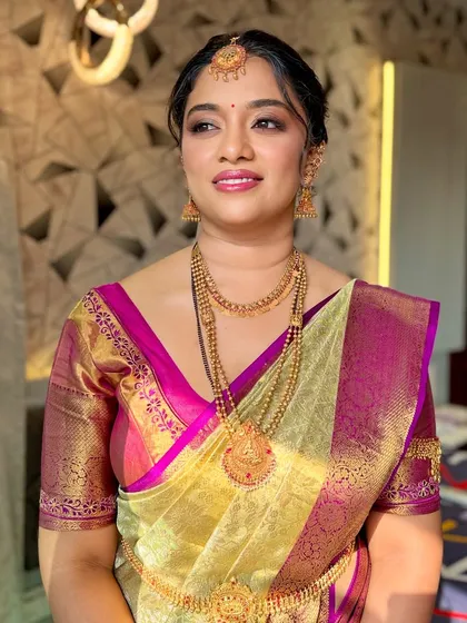 A three-quarter portrait showing the complete look, including the stunning temple jewelry and the perfectly draped Kanjivaram saree.