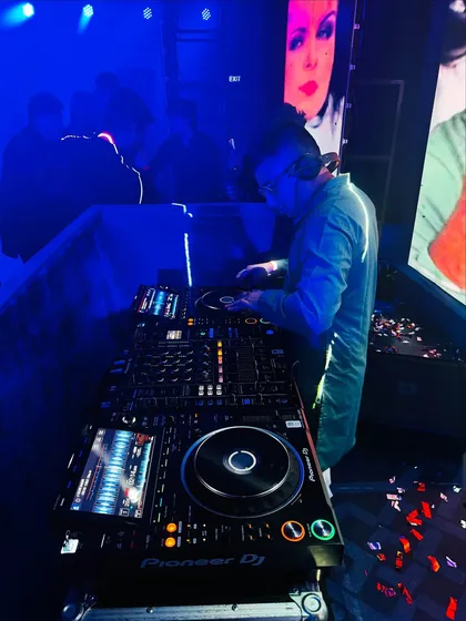 In my element at a wedding reception, with a custom LED screen backdrop. The visuals are just as important as the music for creating the perfect party atmosphere.