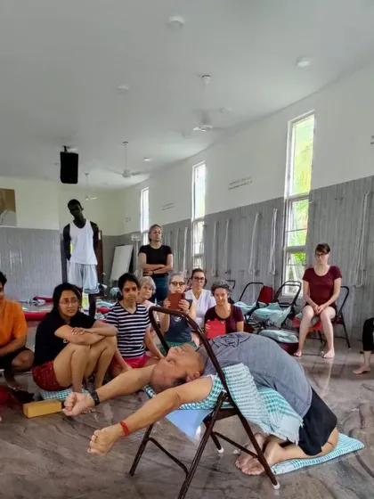 A restorative backbend on a chair during a class.