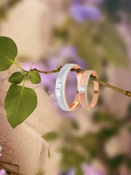 Symbolizing a love that grows, this image shows a set of matching couple bands in rose and white gold. The elegant design is perfect for celebrating your promise of forever.