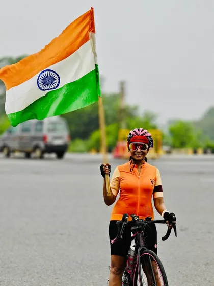 A powerful shot of a female rider holding the Indian flag high during our Independence Day event.